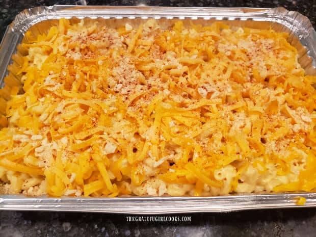 The macaroni and cheese is topped with shredded cheddar, bread crumbs and paprika.