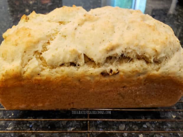 A side view of a loaf of baked sun-dried tomato Parmesan bread.
