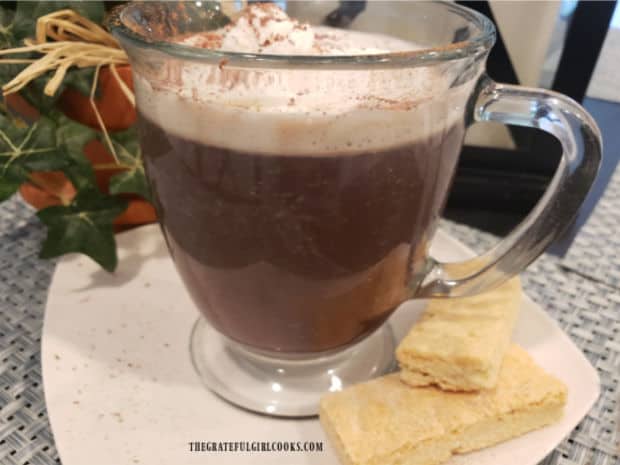 Hot mug of cinnamon mocha coffee, is served with shortbread cookies for a nice treat.