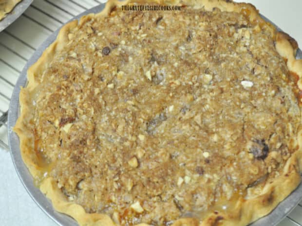 A Dutch Crumb Peach Pie, cooling on a wire rack after baking.