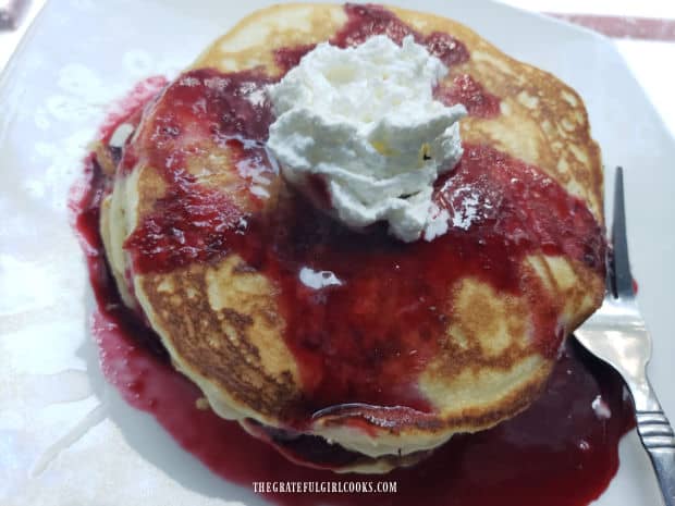 Blackberry syrup and whipped cream top this stack of easy buttermilk pancakes.