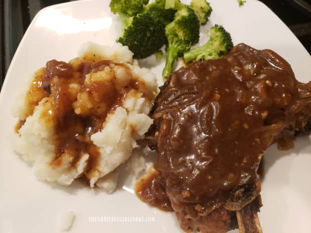 A thick onion gravy tops the smoked smothered pork chops.