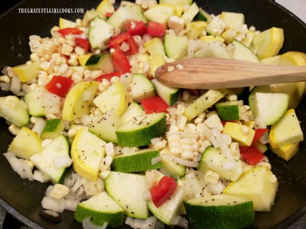 Veggies are cooked in melted butter in a large skillet for a few minutes.