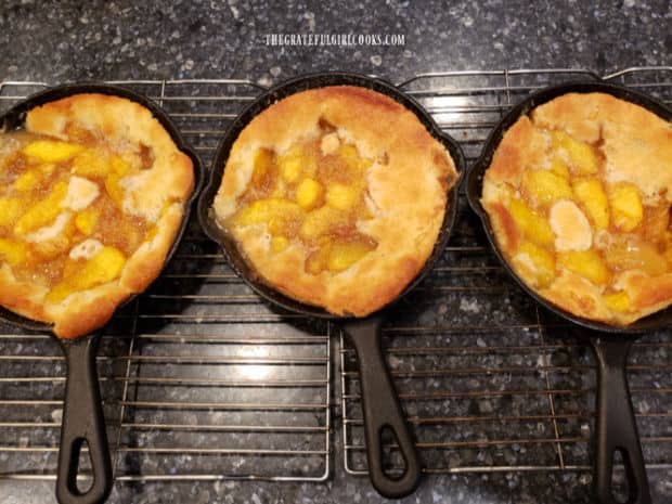 After baking, the mini peach cobbler skillets cool slightly on a wire rack.