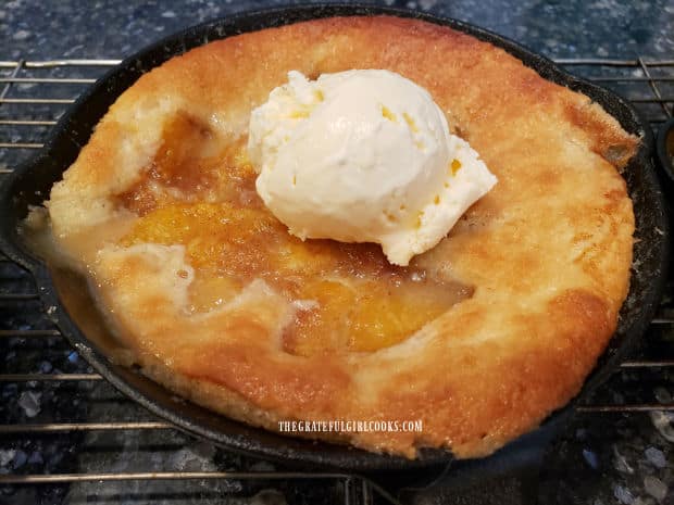 Top each of the mini peach cobbler skillets with a scoop of vanilla ice cream and serve!