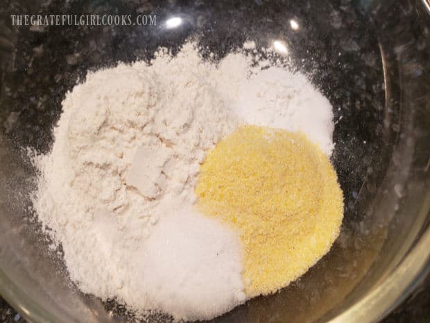 Flour, cornmeal, baking powder, sugar and salt are combined in mixing bowl.