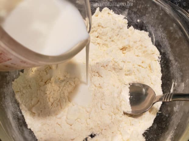 Buttermilk is added to the biscuit mix and stirred until combined.
