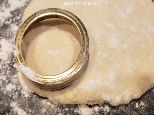 Buttermilk cornmeal biscuits being cut out before baking.