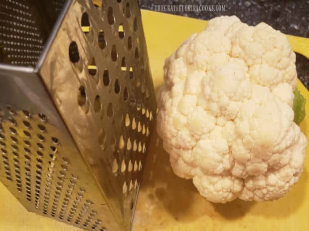 Fresh cauliflower is shredded using a box grater before making the chowder.
