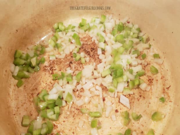 Chopped onions and celery are cooked in reserved bacon grease until tender.