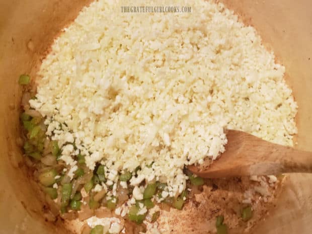 Water and grated cauliflower are added to the soup pot and steamed until tender.