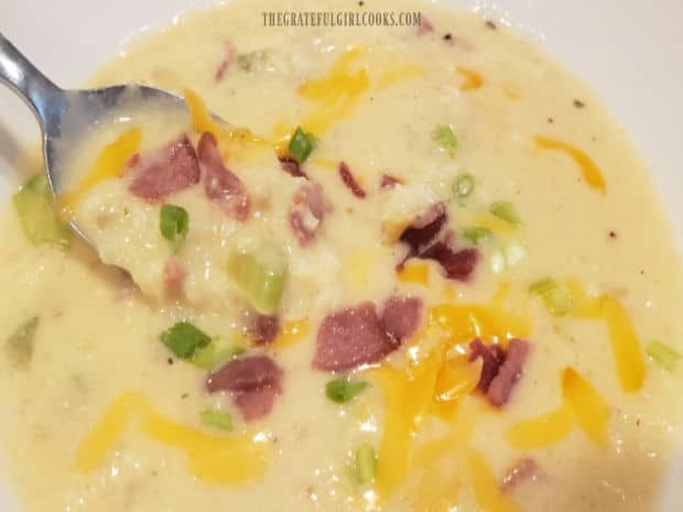 A spoonful of cauliflower bacon chowder, ready to be eaten and enjoyed.