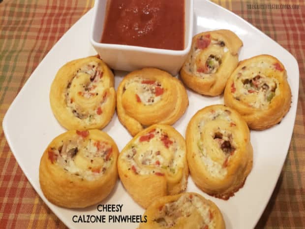 Cheesy Calzone Pinwheels are yummy crescent roll appetizers, with pepperoni, bell pepper, mushrooms, and 3 cheeses, served with marinara sauce.