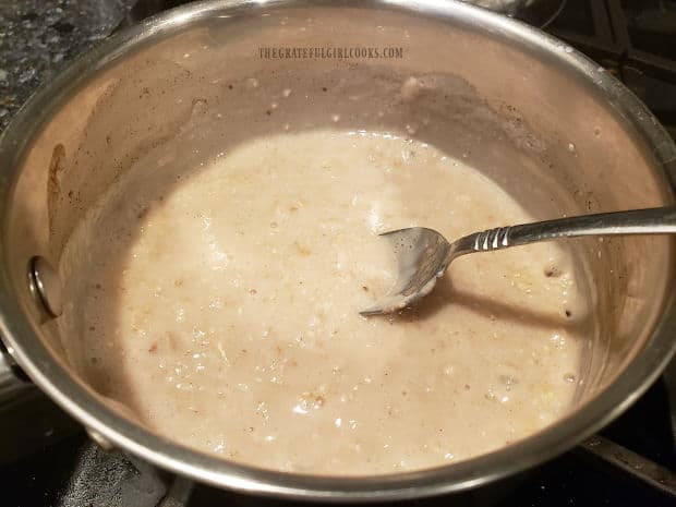 Old-fashioned oats and milk are cooked together in a saucepan.