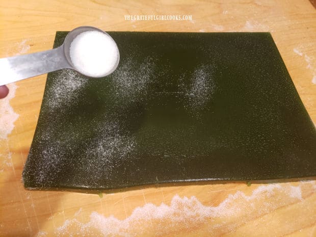 Granulated sugar is lightly sprinkled over the top of the lime gelatin mixture.