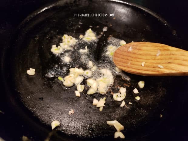 Cooking chopped garlic in butter until lightly browned.