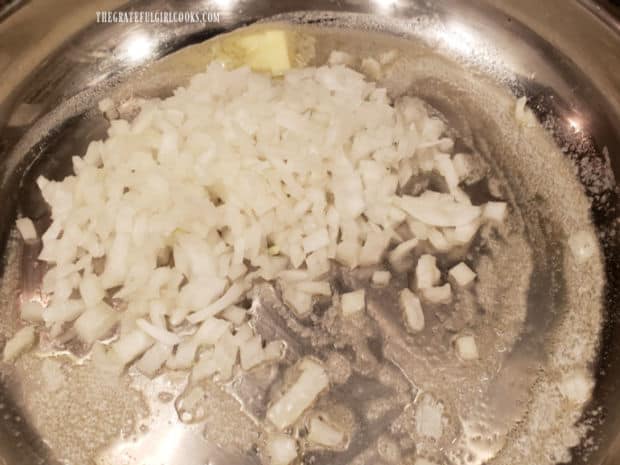 Chopped onions are cooked in melted butter in a large skillet.