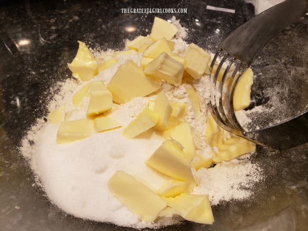 Cold butter is cut into the dry ingredients using a pastry blender.