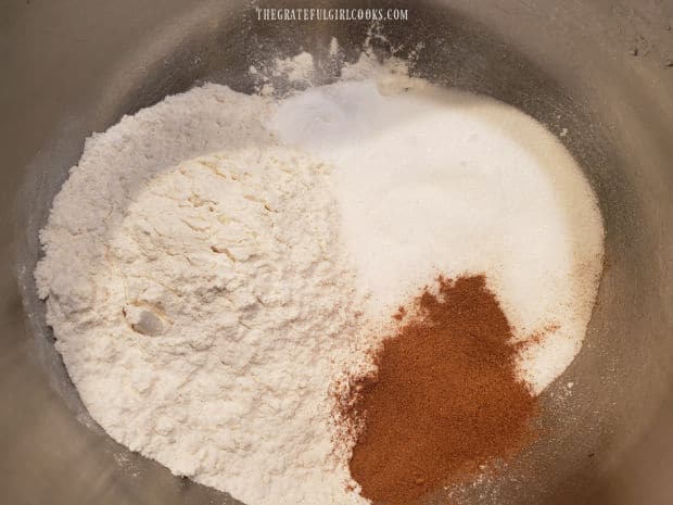 Flour, sugar, pumpkin pie spice mix, baking soda and salt make up the dry ingredients for muffins.