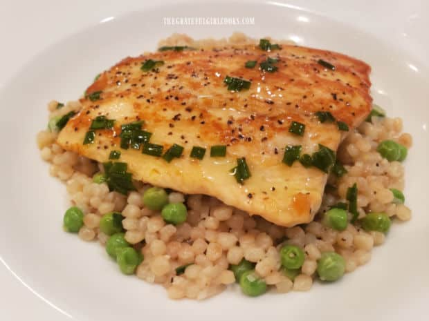 A Salmon and Pearl Couscous Bowl is served with lemon chive drizzling oil on top.