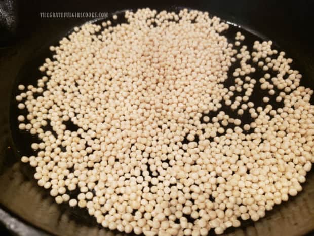Pearl couscous is lightly "toasted" in a hot skillet until golden.