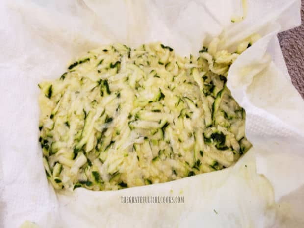 Shredded zucchini is blotted to remove moisture before adding to batter.