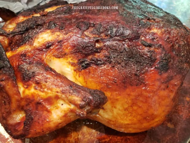 An Air Fryer Whole Chicken after cooking is browned and crispy on the outside.