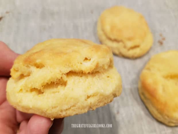 A close up of one of the buttermilk cornmeal biscuits, about to be eaten.