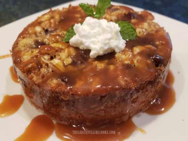 Each of the chocolate caramel pecan tarts is served with caramel sauce, whipped cream and a mint sprig.