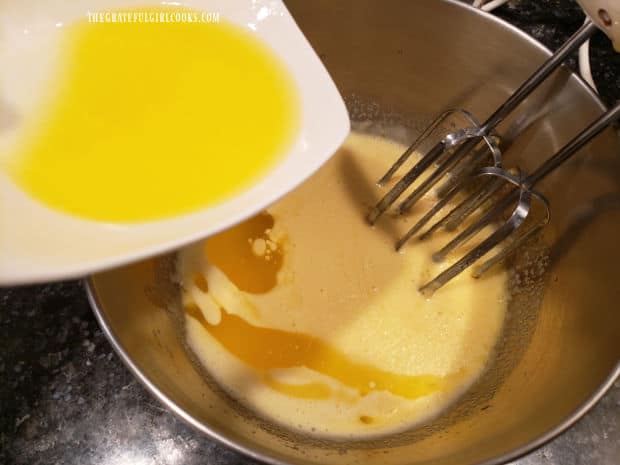 Cooled, melted butter and vanilla extract are added to the pizzelle batter and combined.