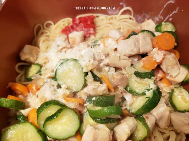 Chicken mixture, Parmesan cheese, pimiento and half and half are added to the pasta.