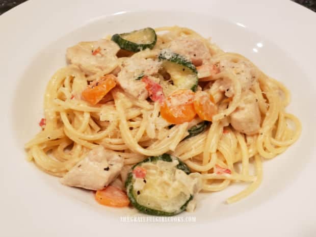 A bowl full of creamy chicken primavera with veggies, ready to eat.