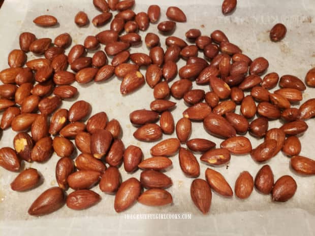 Nicely browned and crunchy, the easy smoky almonds are removed from the oven.
