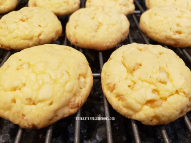 A close up of the lemon krispie cookies cooling on a wire rack after baking.