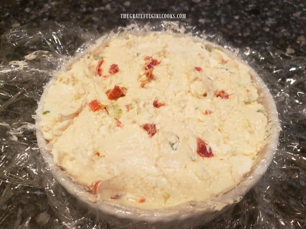 Cheese ball mixture is molded into a container before being refrigerated.