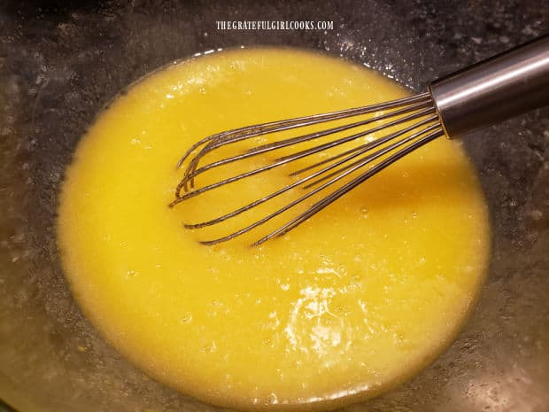 Oil, sugar and eggs are whisked together in mixing bowl until smooth.