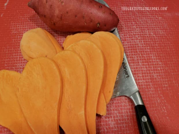 Sweet potatoes are peeled, then sliced into thin wedges.