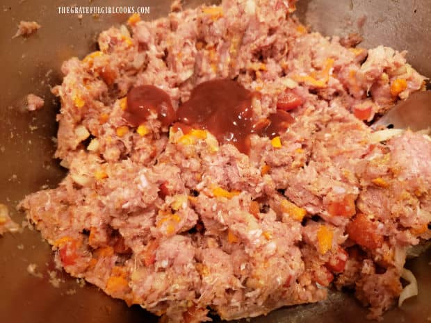 Taco sauce is added to the meatloaf mixture to enhance flavor.