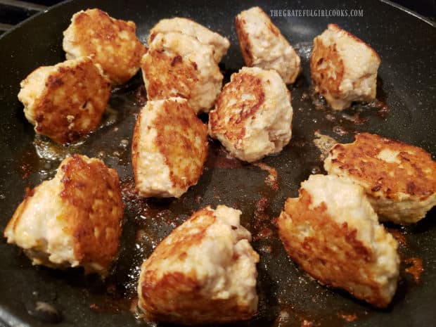 Chicken meatballs are browned on all sides in hot oil until cooked through.