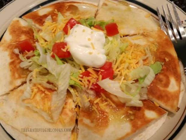 A chicken quesadilla is served, using the shredded chicken inside.