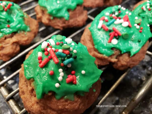 Chocolate mint cookie bites rest on wire racks while frosting firms up.