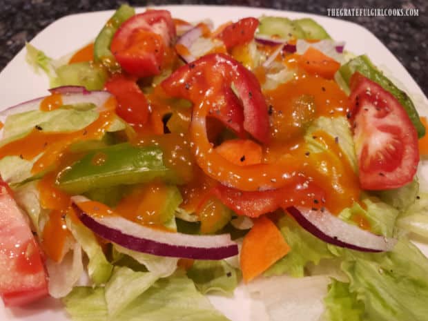 Green salad, ready to eat, topped with French salad dressing.