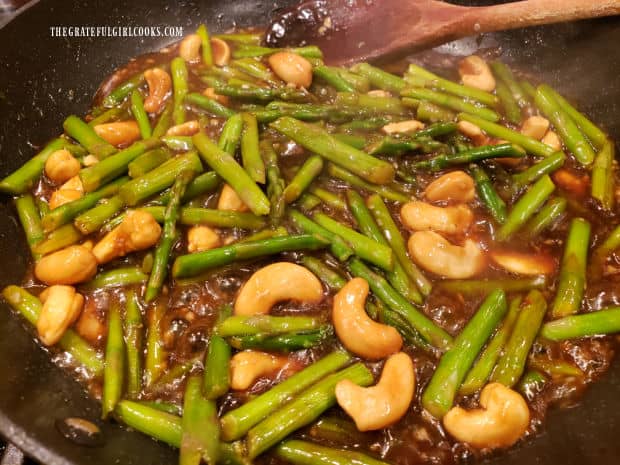 After heating through, the asparagus cashew stir fry is ready to remove from the heat and be served.