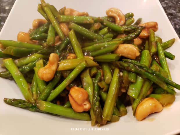 Asparagus Cashew Stir Fry is served in a white bowl.