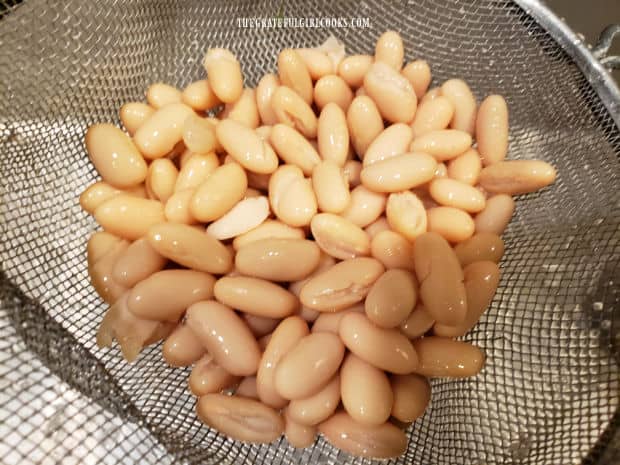 Cannellini beans are drained from the can and rinsed well before making the salad.