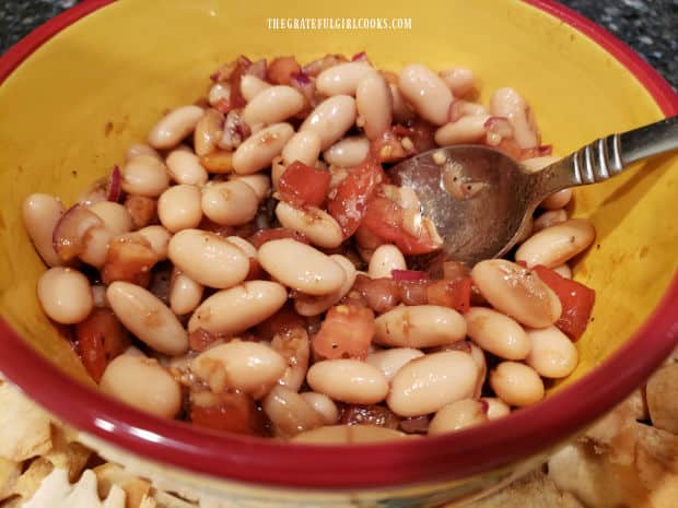 A bowl of cannellini bean salad ready to be served as a dip or eaten as is.