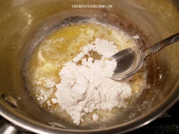 Flour is stirred into melted butter to start making a cheese sauce for the vegetables.
