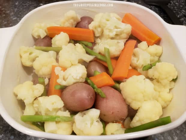 Par-boiled veggies are placed in a buttered 2 quart baking dish.