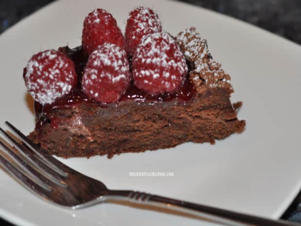 A slice of the chocolate raspberry torte, sliced and served on a white plate.