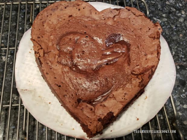 After baking, the torte cools on rack, then sides of the pan are removed and the torte is refrigerated.